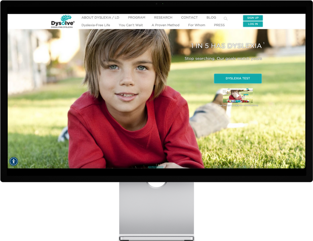 Boy in red shirt lying on grass, website screenshot with Dysolve logo.