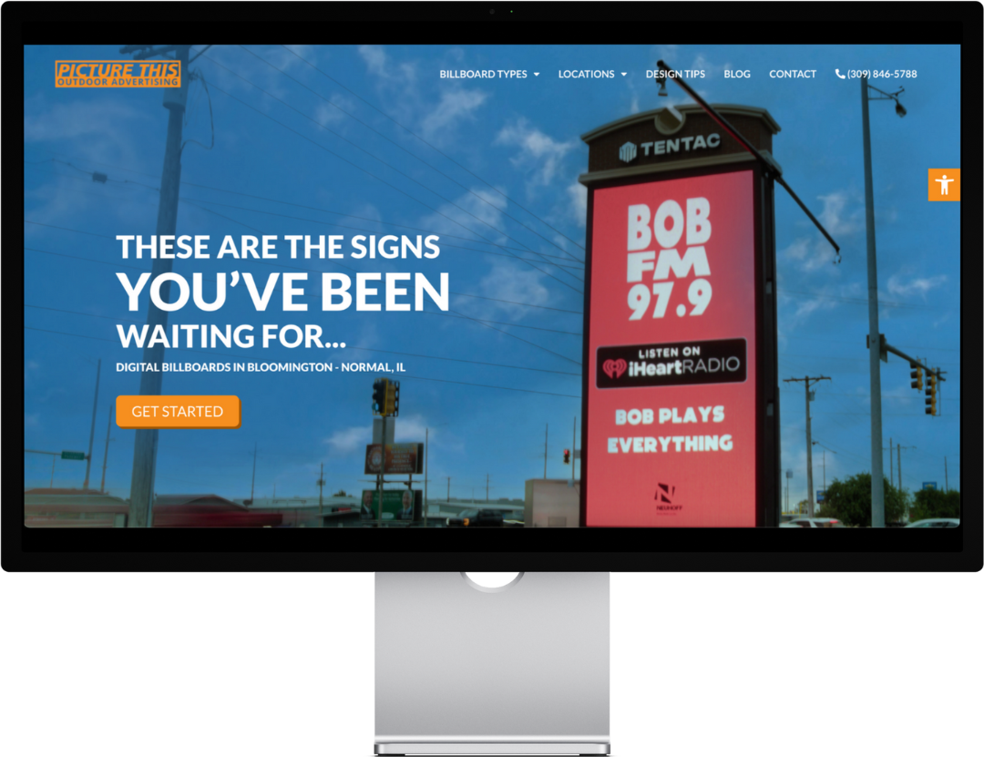 Digital billboard with red "BOB FM 97.9" ad against blue sky.