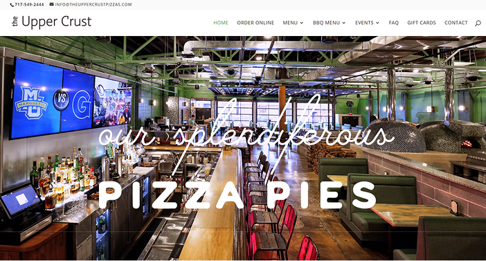 Restaurant interior with bar seating, green walls, and "our splendiferous PIZZA PIES" text.